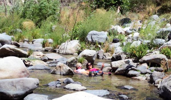 two women enjoying the water in the river
